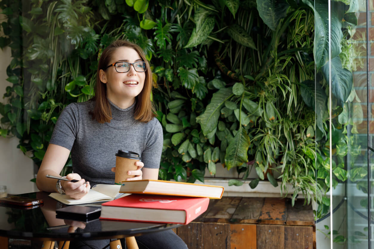 Female Creative smiling while looking out window