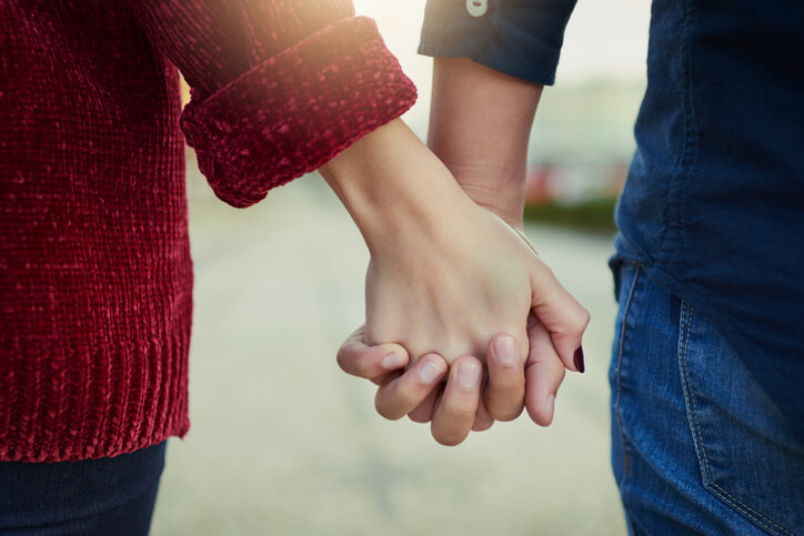 photo of couple holding hands