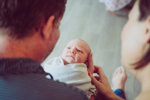 intended parents holding newborn baby