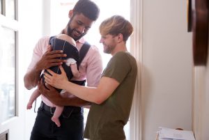 Love is Family, gay male couple with newborn baby through surrogacy