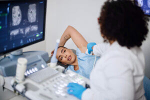 Woman getting a breast cancer check and being diagnosed with breast cancer