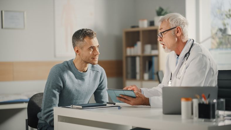 man talking to male infertility specialist