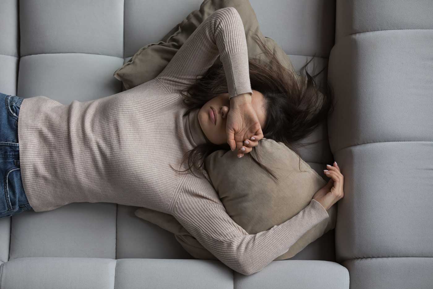 Peaceful girl lying on back on comfortable couch at home