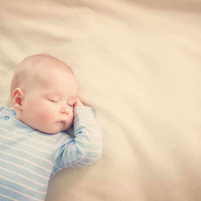 Baby sleeping covered with soft blanket